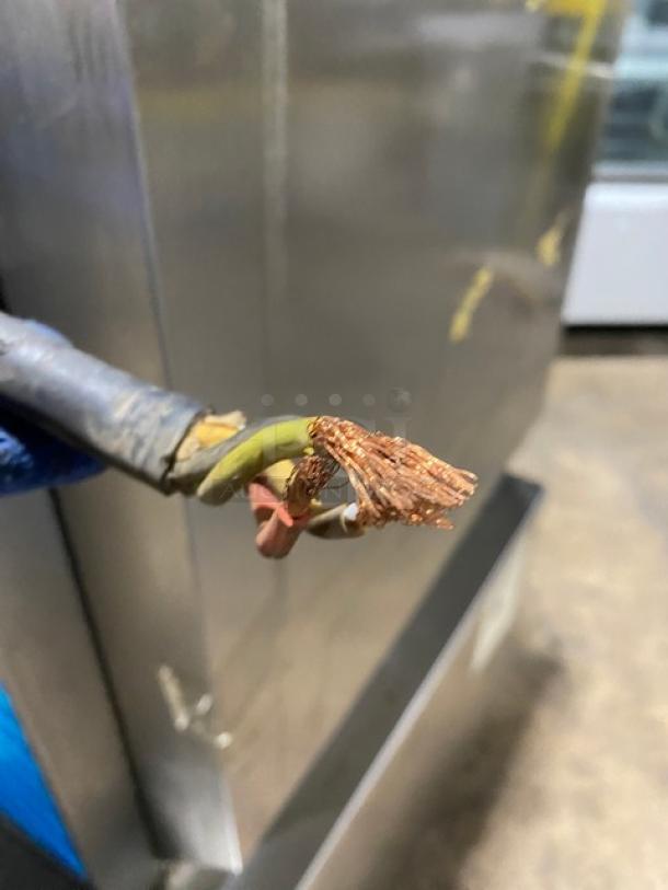 Damaged electric cable of Taylor C70733 soft serve machine; frayed wires visible, needs repair. Machine condition unclear.