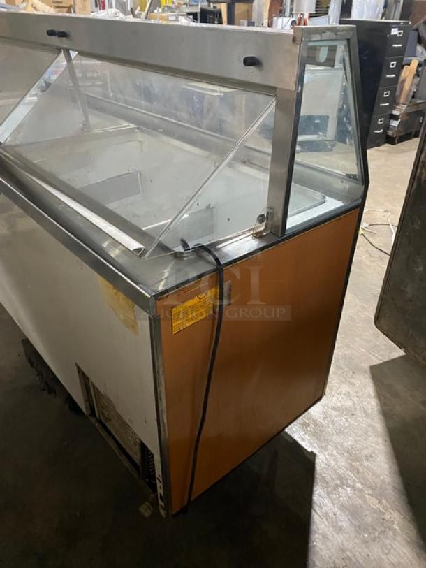 Beverage-Air commercial ice cream cabinet with sneeze guard, rear double lift-up access doors; visible wear, electrical cord attached.