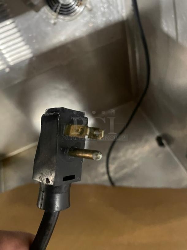 Close-up of a plug for the Silver King SKFSM/C7 refrigerated topping workstation, showcasing electrical compatibility.