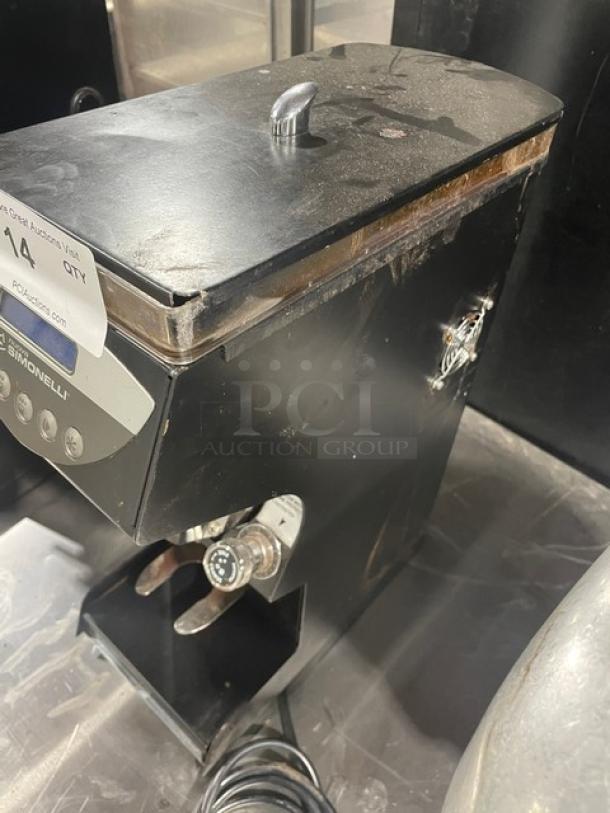 Nuova Simonelli Mythos Silent 2018 espresso grinder, black, electric, countertop model. Features include 110-120V, on legs. Visible wear.