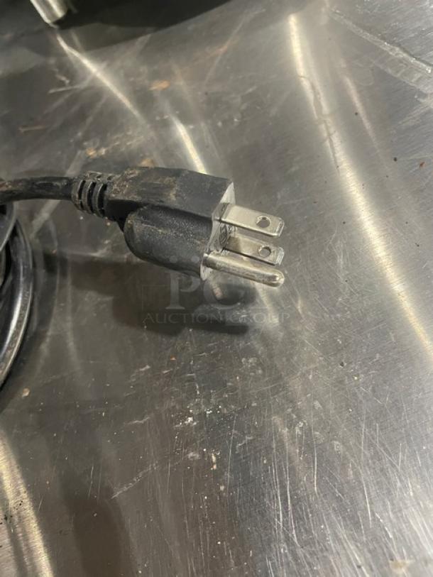 Close-up of a standard electrical plug belonging to a Nuova Simonelli Mythos Silent commercial espresso grinder, 110-120V.
