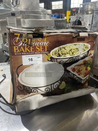 7-piece stoneware bake set with wrought iron stands, new condition, original packaging, includes various bakeware shown on box.