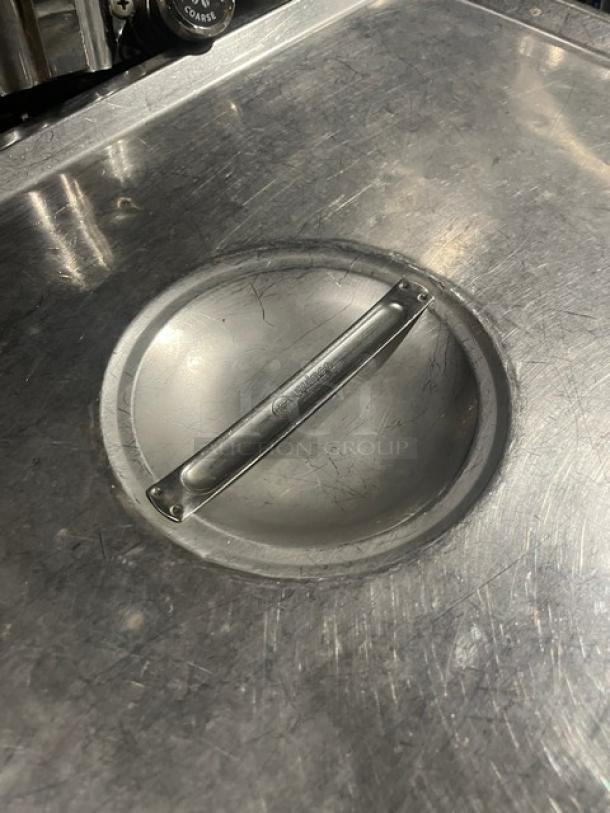 Commercial stainless steel pan lid, durable with handled grip, suitable for hotel steamtable use; minor surface scratches.