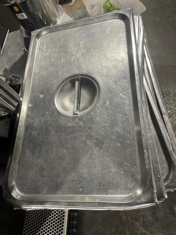 Commercial stainless steel steamtable pan lids, slightly used, stack of six with handles, ideal for hotel or kitchen use.