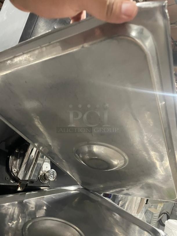 Stainless steel hotel steamtable pan lid, used condition, sturdy construction, smooth top surface with handle indentation.