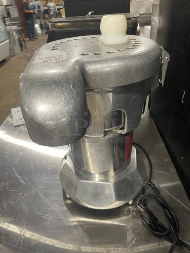 Ruby 2000 commercial stainless steel electric juice extractor, model SN: 7681, 115-117V, on legs, some surface wear.