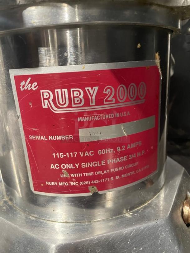 The Ruby 2000 stainless steel electric juice extractor with red label. Model RUBY2000, SN 7681, 115-117V, on legs.