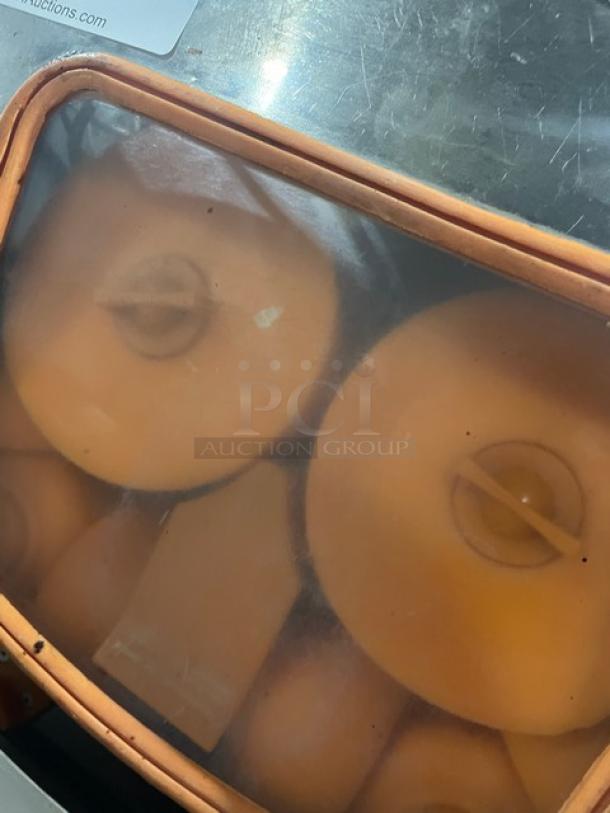 Nantong Rong XC2000E3 stainless steel electric orange/lemon squeezer, visible internal components, good condition, 110V.