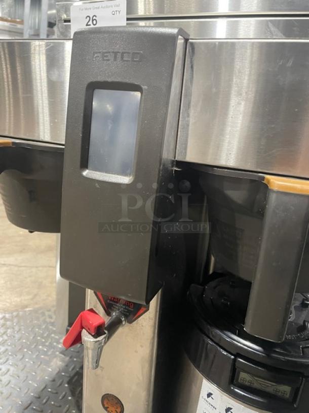 Fetco CBS-2132-XTS stainless steel commercial double coffee brewer with hot water dispenser, model CBS2132XTS, on legs.