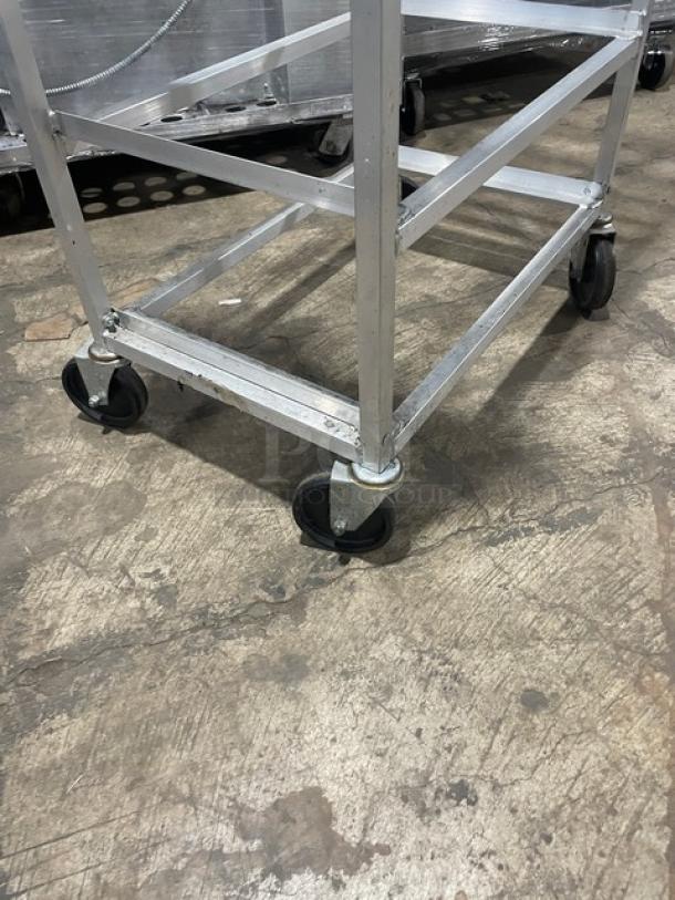 Channel SRS-7 slanted aluminum display rack with casters, commercial use. Sturdy build, mobile design, excellent condition.
