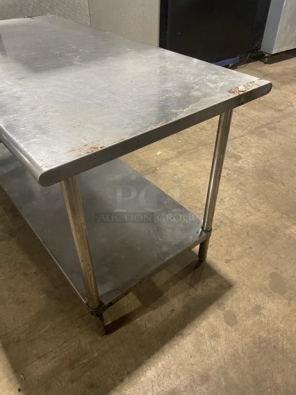 Sapphire stainless steel worktop table with undershelf, sturdy legs, slight surface wear, ideal for commercial use.