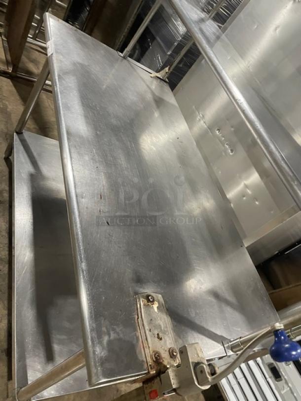 Sapphire stainless steel worktop table with single undershelf and double overhead shelf, Edlund manual can opener attached; used condition.