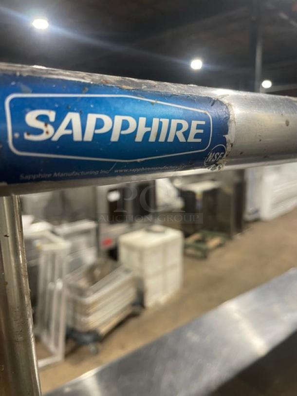 Sapphire stainless steel worktop table with single undershelf, double overhead shelf, Edlund can opener, visible wear, labeled.