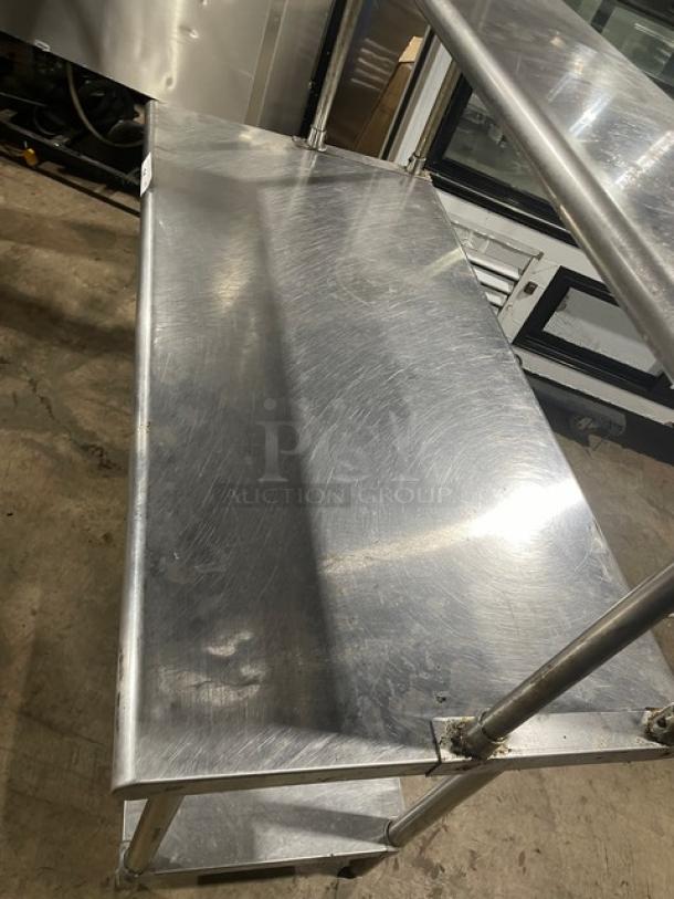 Sapphire stainless steel worktop table with single undershelf and double overhead shelf. Features sturdy legs, commercial-grade.