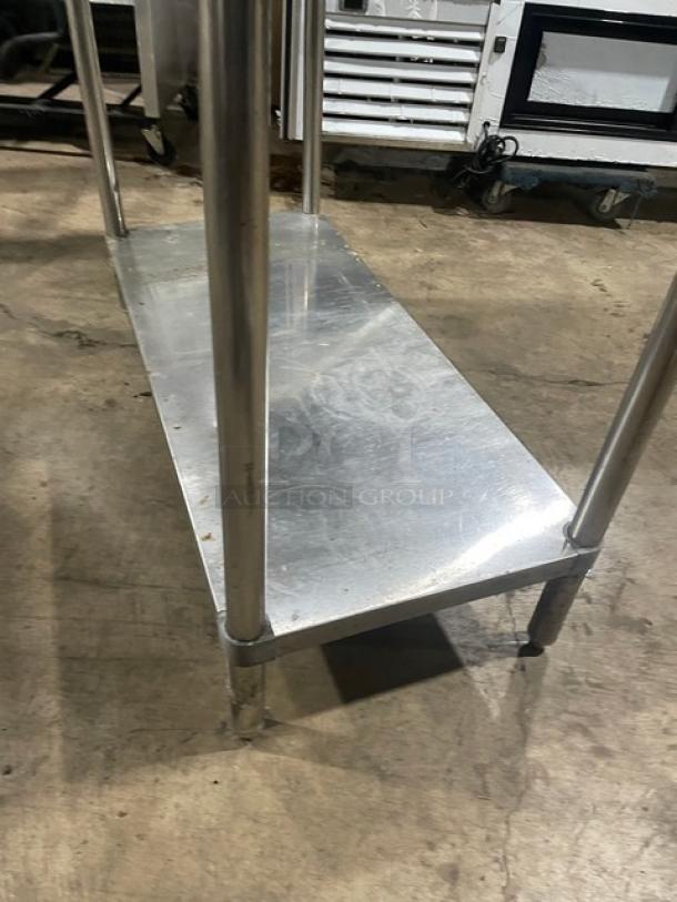Sapphire stainless steel worktop table with single undershelf and double overhead shelves, on sturdy legs. Excellent condition.