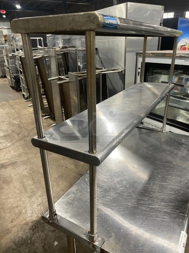 Sapphire commercial stainless steel worktop table with single undershelf and double overhead shelves on legs; used condition.