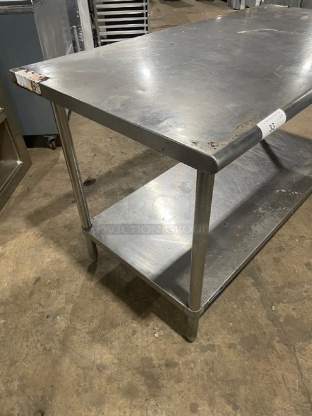 Sapphire stainless steel worktop table with single undershelf, on sturdy legs. Features minor wear, showcasing durability.
