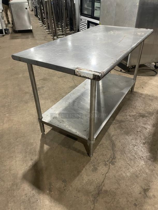 Sapphire commercial stainless steel worktop table with single undershelf, on legs. Visible wear on edges.