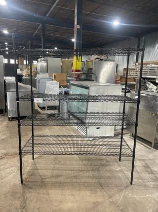 Commercial black 4-tier utility wire rack on legs, excellent condition, ideal for storage, sturdy and spacious design.