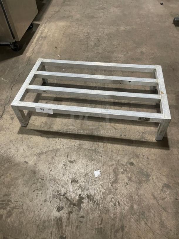 Commercial aluminum dunnage rack on legs, sturdy metal construction, rectangular design, measures approximately 30x18x8 inches, used condition.