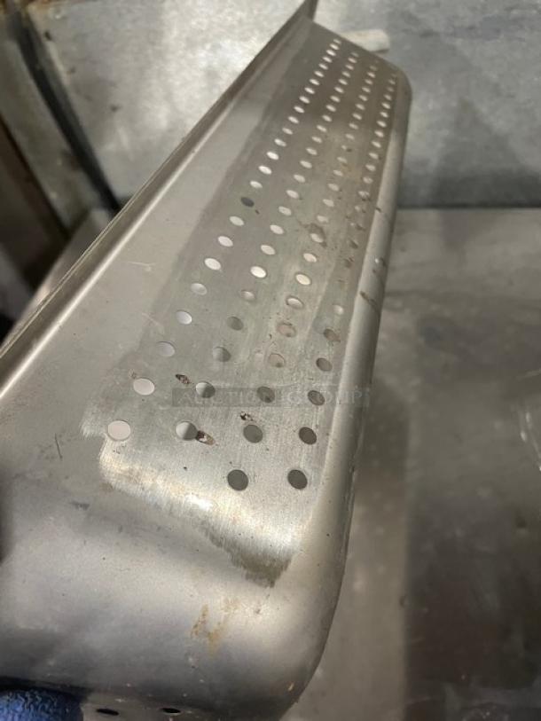 Commercial stainless steel perforated hotel/steamtable pan; durable, used condition with visible surface scratches.