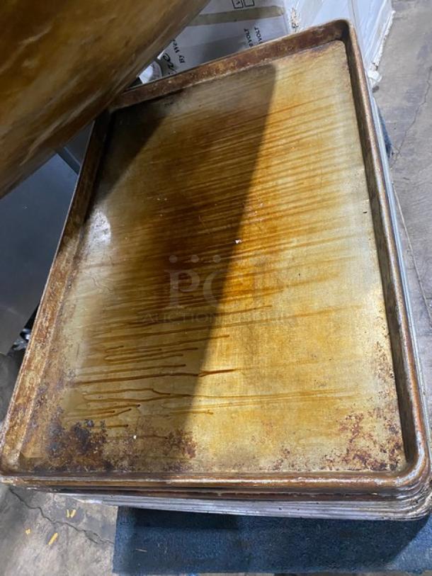 Commercial full-size baking sheet pan showing signs of use, with visible wear and patina, ideal for high-volume baking.