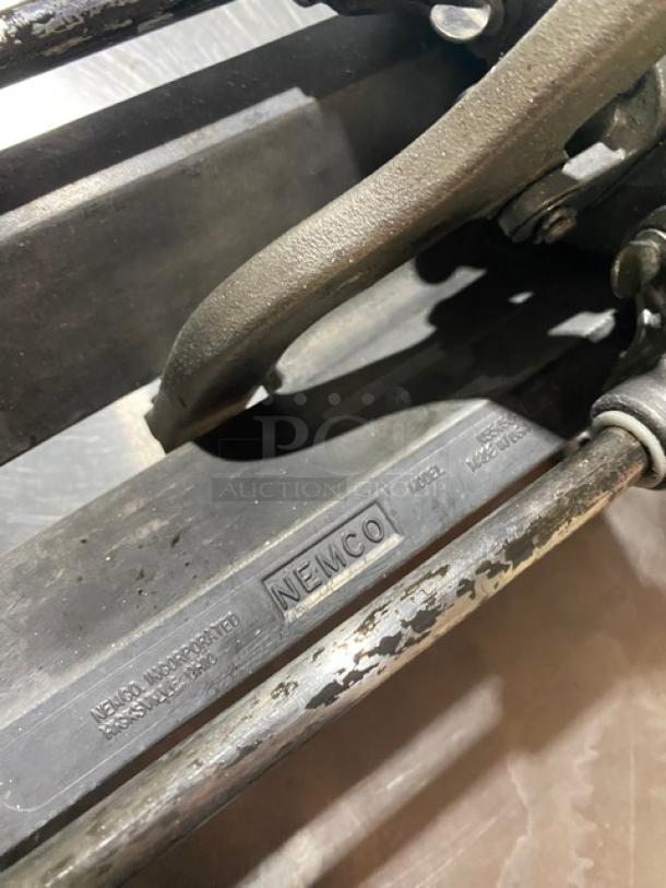Nemco commercial heavy-duty manual countertop French fry/potato cutter in used condition, metal body with Nemco branding visible.
