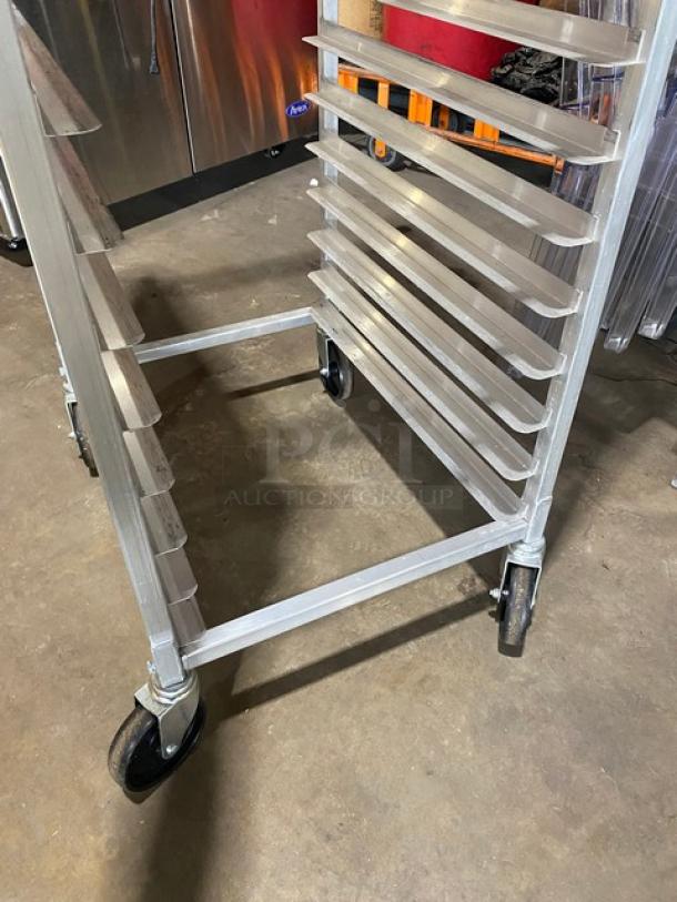 Winco ALRK-20 aluminum 20-pan end-load transport rack on casters, in good condition.