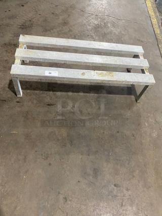 Commercial aluminum heavy duty dunnage rack with legs. Sturdy construction, used condition, ideal for storage needs.