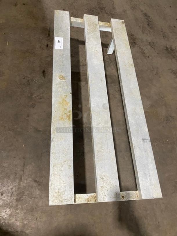 Commercial aluminum heavy-duty dunnage rack on legs, showing some wear, ideal for storage. Label marked with "85".