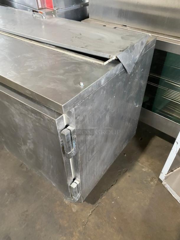 Beverage-Air SP60-16 stainless steel refrigerated prep table, two doors, casters, visible wear, ideal for commercial use.