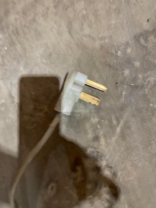 Power plug for Nu-Vu NCO5 convection oven, 208V 1 phase, shown on concrete surface.