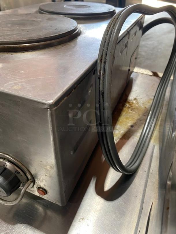 Wells H70 stainless steel electric 2-burner hotplate with individual controls, showing power cord and dial.