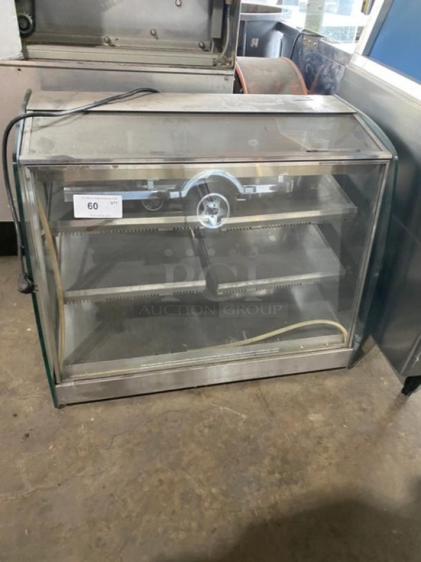 Vendo stainless steel heated food merchandiser, countertop model, with rear sliding glass doors, 115V, good condition.