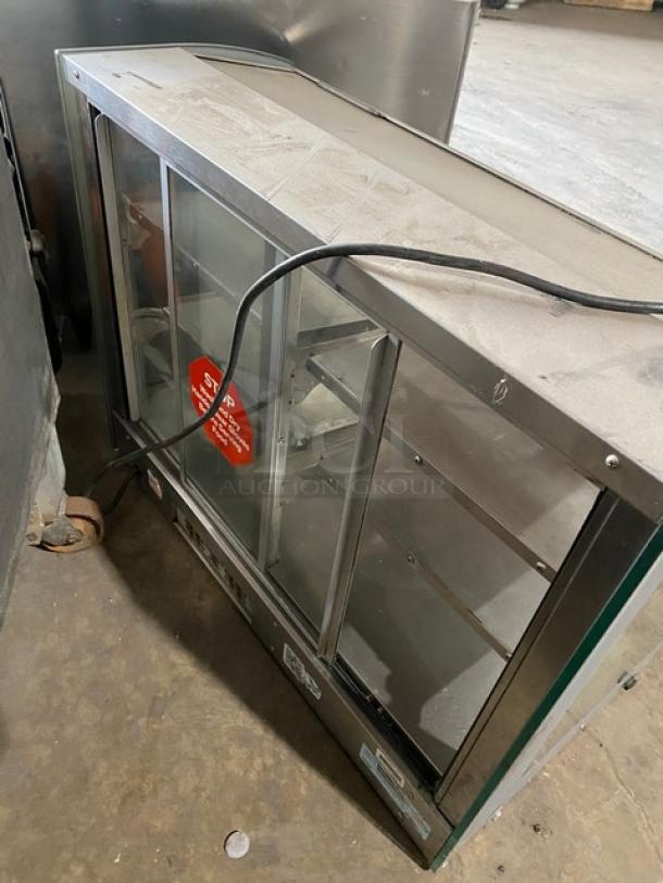 Vendo stainless steel electric countertop hot food merchandiser with rear glass sliding doors, 115V, good condition.
