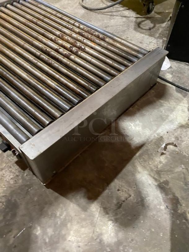 Nemco commercial stainless steel electric countertop hot dog roller grill, lightly rusted rollers, visible power cord.