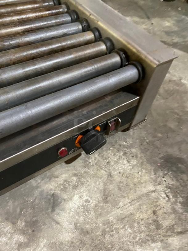Nemco stainless steel electric hot dog roller grill, features multiple rollers and control knobs, used condition.