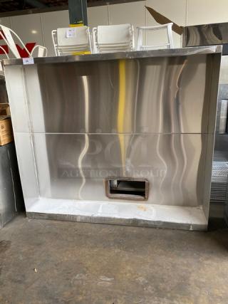 Commercial stainless steel kitchen exhaust hood, large, vent opening, shiny finish, good condition, ideal for restaurants.