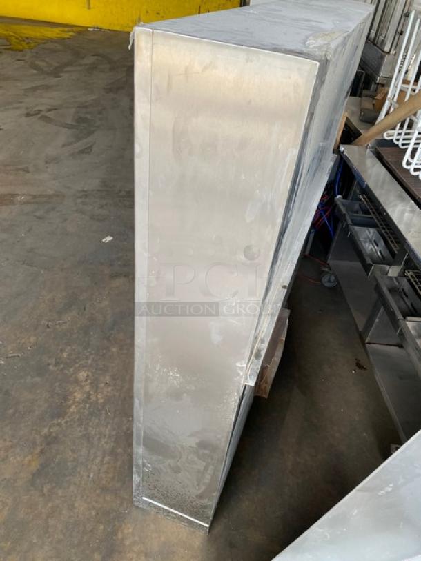 Stainless steel kitchen exhaust hood, commercial-grade, in new condition. Ideal for restaurant kitchens, durable and sleek design.