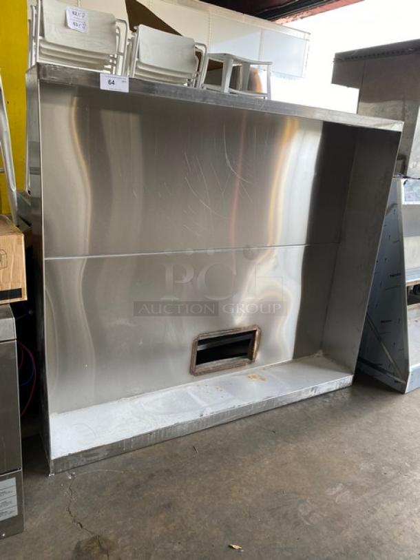 Commercial stainless steel kitchen exhaust hood, large, industrial-grade, used condition, with visible vent opening.