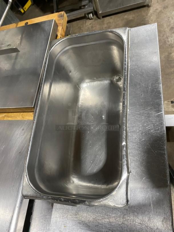 Commercial stainless steel hotel/steamtable pan, rectangular, used condition, durable design. Ideal for catering purposes.