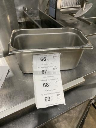 Stainless steel hotel steamtable pan on countertop, showing good condition with auction slips indicating bidding options.