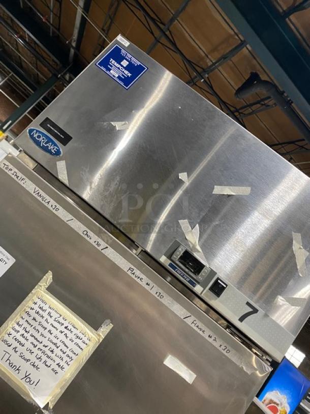 Norlake NF241SSS0 commercial stainless steel reach-in freezer, single door, with poly-coated wire rack, on casters.