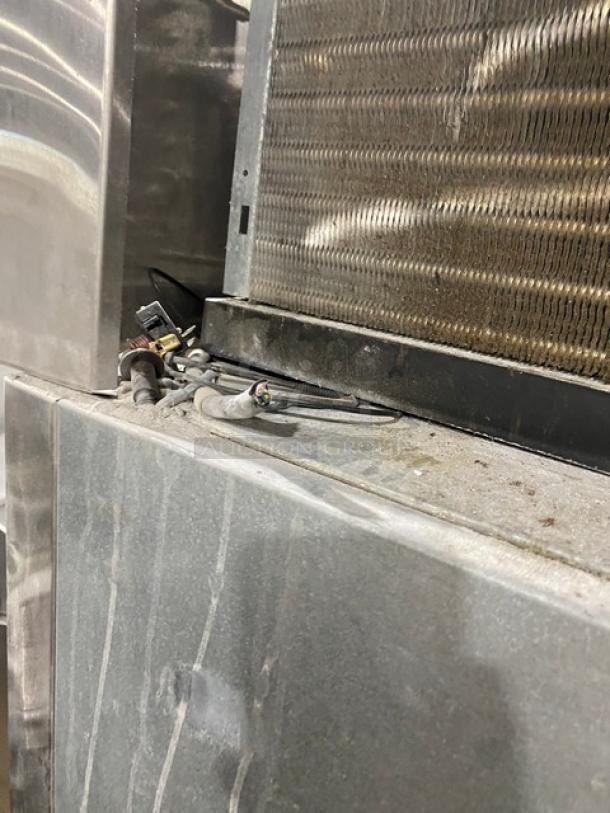 Norlake commercial stainless steel single-door reach-in freezer, model NF241SSS0, with poly-coated wire rack, on casters.