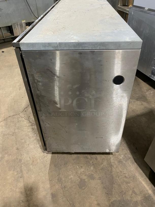 Perlick 4-door stainless steel refrigerated back bar cabinet with poly-coated wire rack, SN: 518921. Visible wear.