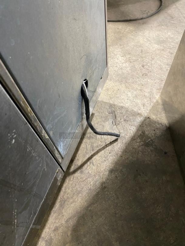 Perlick commercial stainless steel 4-door refrigerated back bar cabinet, visible wiring. Poly coated wired rack. SN: 518921.