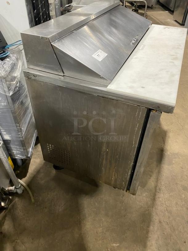True TSSU-48-12 stainless steel 2-door refrigerated prep table with cutting board, poly-coated rack, casters; shows wear.
