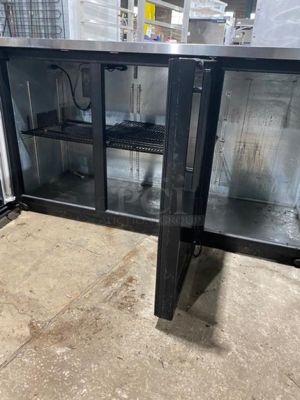 True TBB-24-72G commercial black triple glass swing door refrigerated back bar cabinet with stainless steel worktop and wired rack.