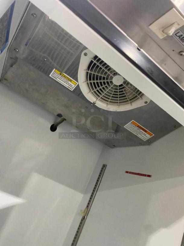 Beverage-Air KR24-1AS refrigerator interior with cooling fan, labels, and adjustable rack slots; clean condition.