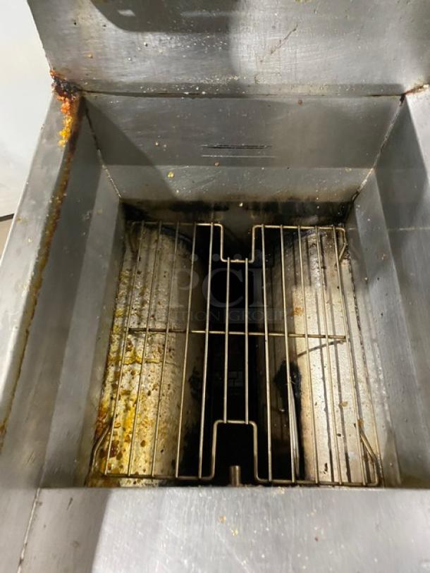 Frymaster GF40SC stainless steel natural gas fryer, interior view, with basket hanger and casters, showing wear.